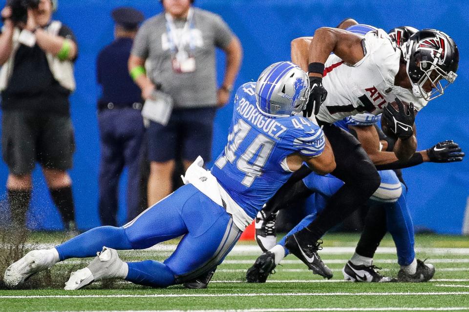 Detroit Lions linebacker Malcolm Rodriguez (44) tackles Atlanta Falcons running back Bijan Robinson (7) during the first half at Ford Field in Detroit on Sunday, Sept. 24, 2023.