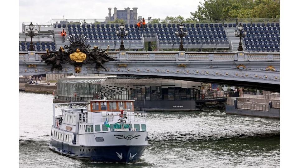 A boat going underneath a bridge in Paris