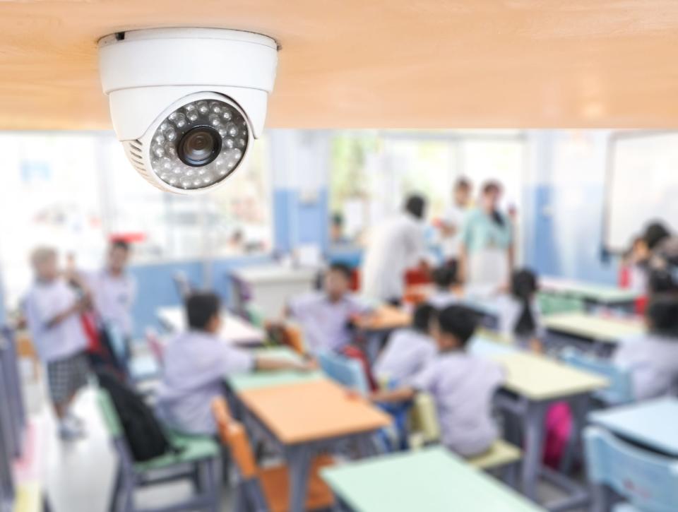 CCTV security monitoring students in a classroom at school.
