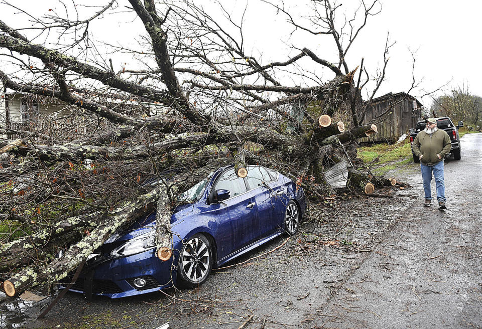 Greg Crist walks down Lookout Road in Hico, W.Va., Wednesday, April 3, 2024, as he looks over the damage from a storm that hit in the area the day before. (Rick Barbero/The Register-Herald via AP)