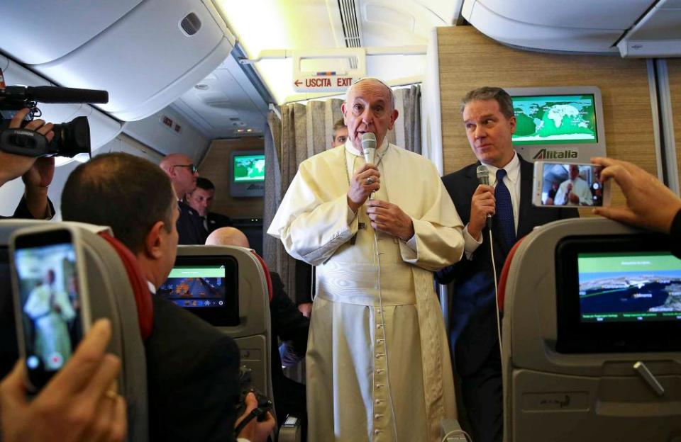 Pope Francis speaks to reporters on a plane en route to Chile and Peru.