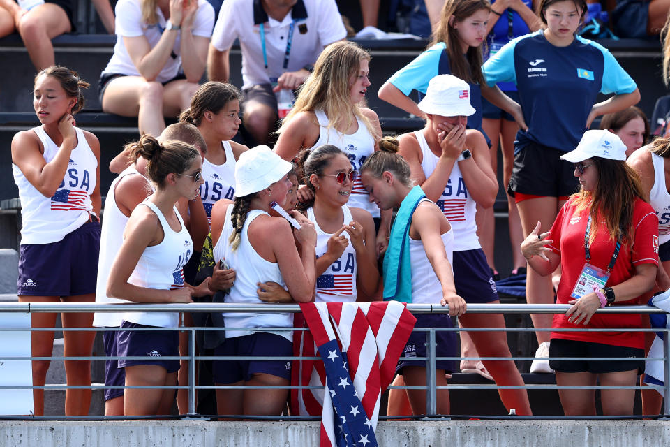 Members of the American team, pictured here visibly shaken by the incident.