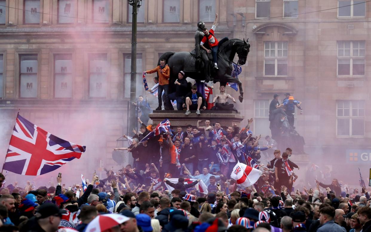 Rangers fans celebrate winning the Scottish Premiership in George Square on Saturday - PA