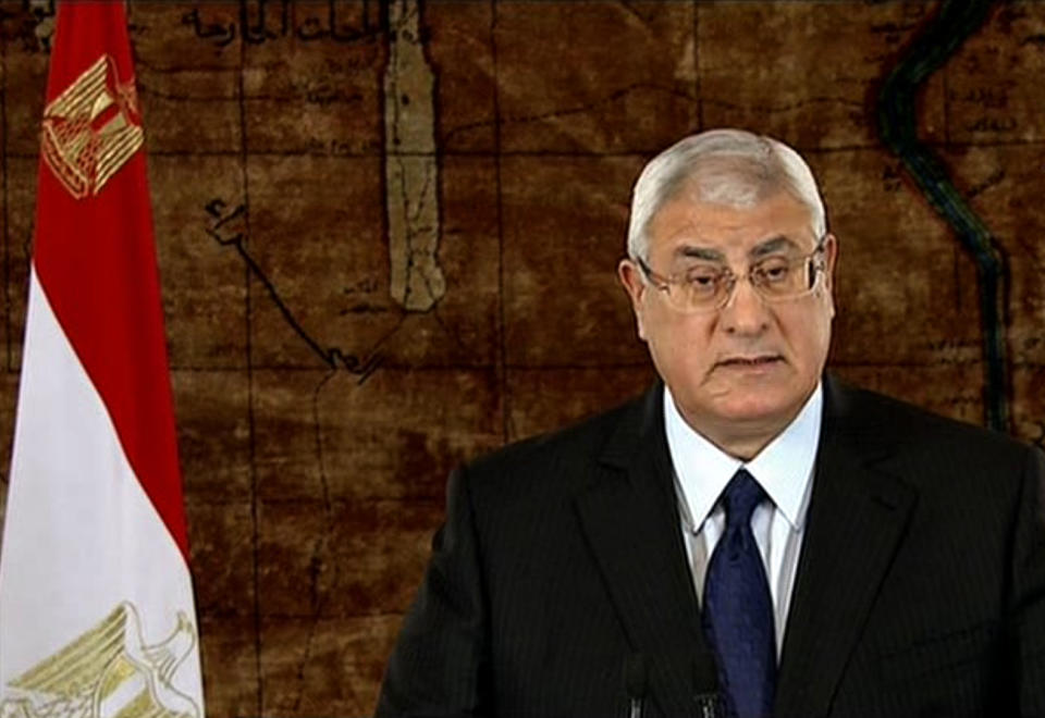 In this image made from video broadcast on the Egyptian State Television, Egypt's interim President Adly Mansour speaks at the presidential palace in Cairo, Egypt, Sunday, Jan. 19, 2014. Mansour, in a televised address to the nation on Sunday night, sought to reassure young Egyptians that they will not be sidelined. (AP Photo/Egyptian State Television via AP video)