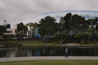 A man strolls past the Long Beach Convention Center, Thursday, April 22, 2021, in Long Beach, Calif., where migrant children found at the U.S.-Mexico border without a parent will be temporarily housed. The center is able to house up to 1,000 children and the first children are expected to arrive Thursday afternoon. (AP Photo/Jae C. Hong)