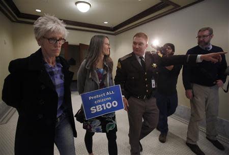 LGBT rights activist are detained by members of the Utah Highway Patrol after blocking a Senate committee hearing room at the Utah State Capitol, February 10, 2014, in Salt Lake City, Utah. REUTERS/Jim Urquhart