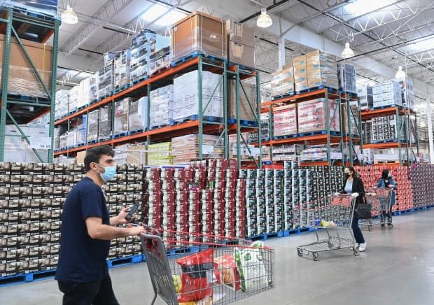 Shifting consumer demand, from shopping online to spending more on products for the home, is one reason some products are in short supply. Here, people shop at a Costco in Mississauga, Ont., on April 8. (Nathan Denette/The Canadian Press - image credit)