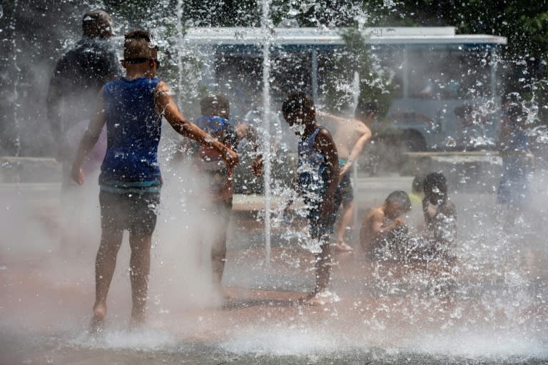 Unos niños se refrescan en una fuente del parque de Greenway para combatir la ola de calor, el 19 de junio de 2024 en Boston, al noreste de EEUU (Joseph Prezioso)