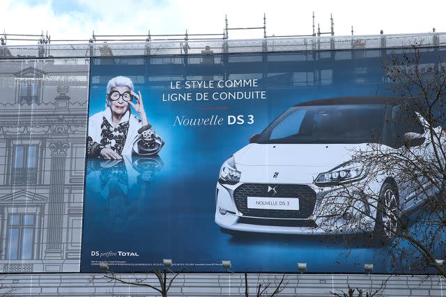 <p>Bertrand Rindoff Petroff/Getty </p> A billboard featuring Iris Apfel in Paris in 2016