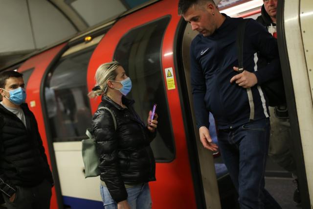 Commuters, some wearing PPE (personal protective equipment) including face masks as a precautionary measure against COVID-19,  travel by public transport during the evening 'rush hour', on TfL (Transport for London) underground trains, in central London on May 14, 2020. - Britain has had more than 36,000 deaths in the outbreak -- the second-worst in the world -- but has partially lifted lockdown measures in England this week. The government has been accused of putting workers' lives at risk by easing restrictions while the daily death toll is still hovering around 500. (Photo by Isabel Infantes / AFP) (Photo by ISABEL INFANTES/AFP via Getty Images)