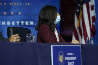 Neera Tanden who President-elect Joe Biden nominated to serve as Director of the Office of Management and Budget listens as Biden speaks at The Queen theater, Tuesday, Dec. 1, 2020, in Wilmington, Del. (AP Photo/Andrew Harnik)