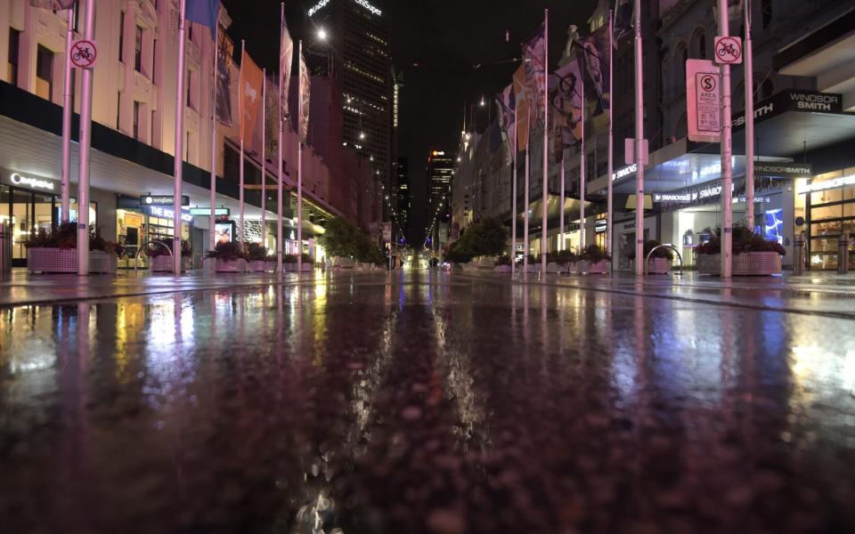 Bourke Street Mall in Melbourne stands deserted during an overnight curfew -  Carla Gottgens/Bloomberg