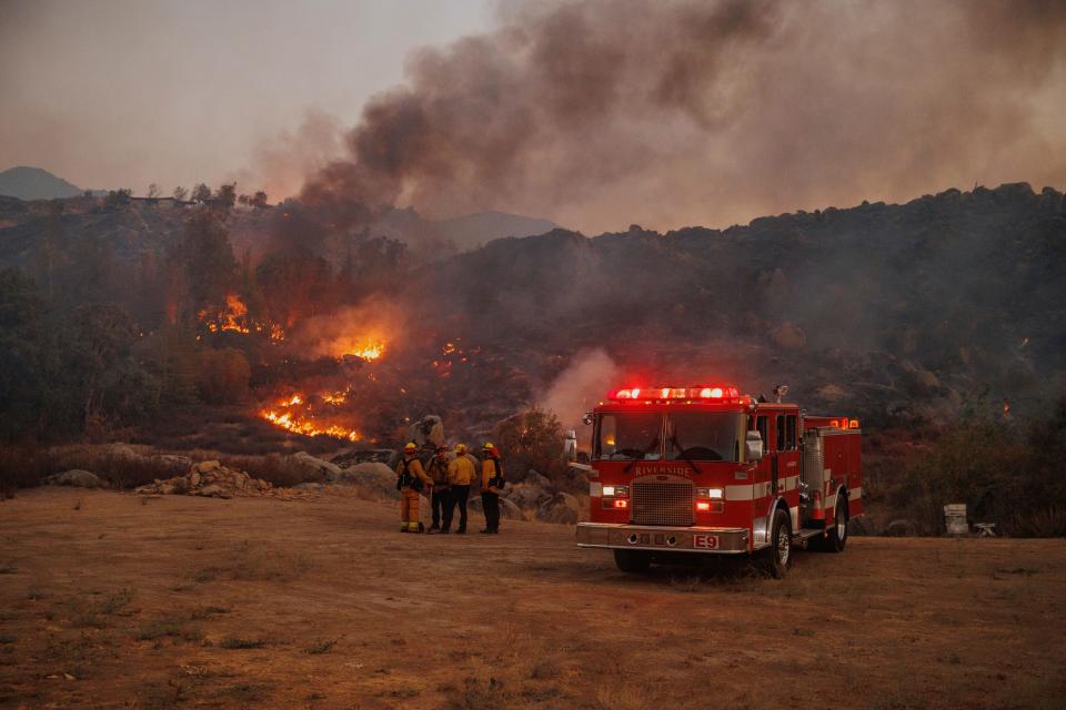 Firefighters stage in front of the Fairview Fire near Hemet, California, on Monday, Sept. 5, 2022.