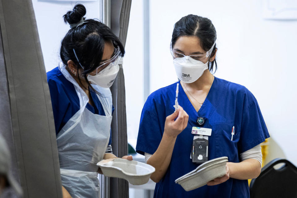 Staff are seen preparing to administer COVID-19 vaccines inside the Melbourne Showgrounds COVID-19 Vaccination Centre.