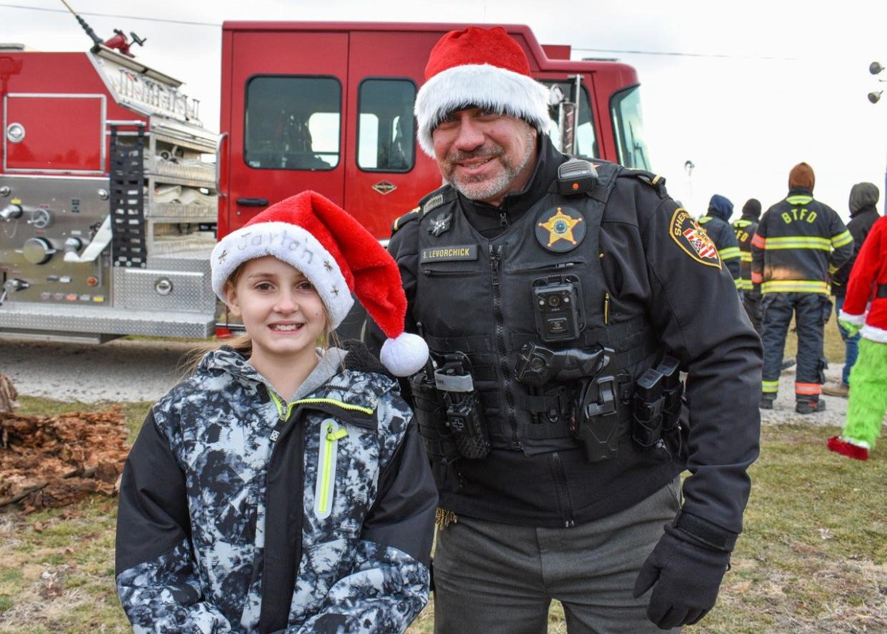 Ottawa County Sheriff Stephen Levorchick, right, planned to offer child identification cards to parents at the Dec. 18 Reindeer Days event at Hopfinger Zimmerman Memorial Park, but frigid weather prevented him. Instead, he hung out with kids like nine-year-old Jaylah Mincer from Oak Harbor, shown here.