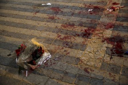 A bouquet stained with blood is seen where, according to Israeli police spokesperson, at least 10 Israelis were stabbed, in the popular Jaffa port area of Tel Aviv, Israel March 8, 2016. REUTERS/Amir Cohen