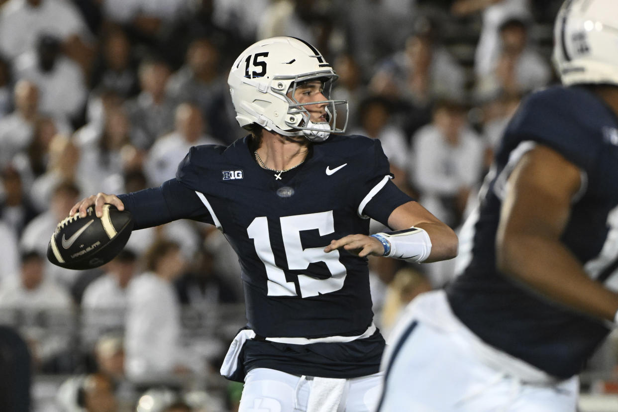 Penn State quarterback Drew Allar (15) throws a pass against Illinois during the first quarter of an NCAA college football game, Saturday, Sept. 28, 2024, in State College, Pa. (AP Photo/Barry Reeger)