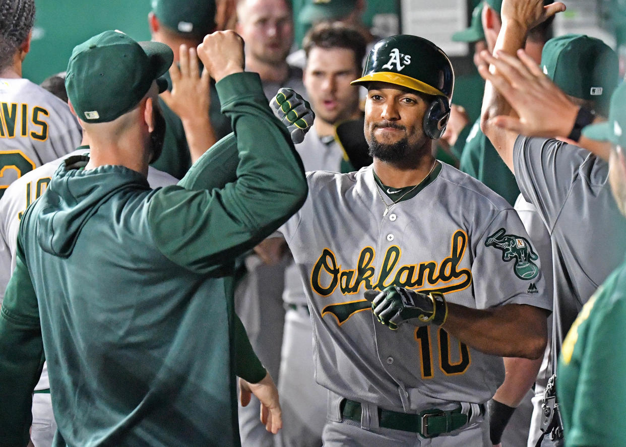 Aug 26, 2019; Kansas City, MO, USA; Oakland Athletics shortstop Marcus Semien (10) celebrates in the dugout after hitting a three run home run during the third inning against the Kansas City Royals at Kauffman Stadium. Mandatory Credit: Peter G. Aiken