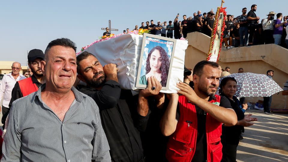 Mourners carry the coffin of a victim during a funeral in Hamdaniya, Iraq, on September 27. - Khalid Al-Mousily/Reuters