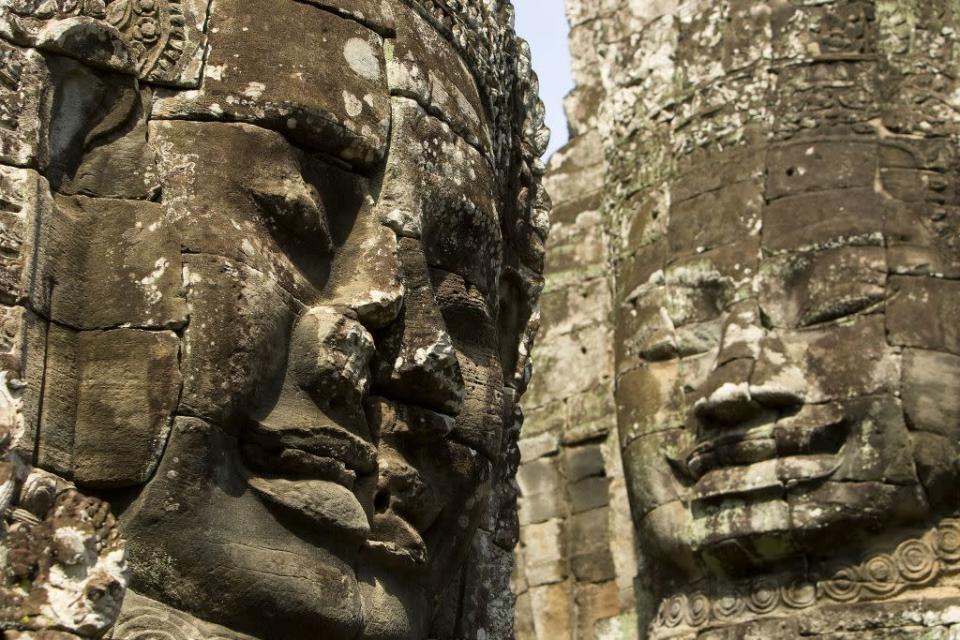 The faces carved into the Bayon temple appear to wear an expression of peace.