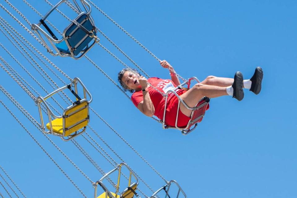 Jillian Dongo rides the Wave Swinger at the California State Fair on Tuesday. The Wave Swinger lifted riders into the air and swung them around in a circle before lowering them to the ground once more.