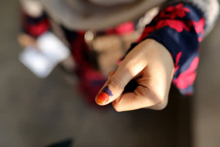 A woman displays her inked thumb after casting her vote for the general election in Dhaka, Bangladesh, December 30, 2018. REUTERS/Mohammad Ponir Hossain