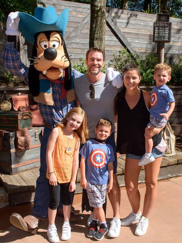 <p>Todd Anderson/Disney Parks/Getty</p> Scott Foley, Marika Dominczyk and their children, Konrad, Malina and Keller, meet Goofy at Magic Kingdom Park.