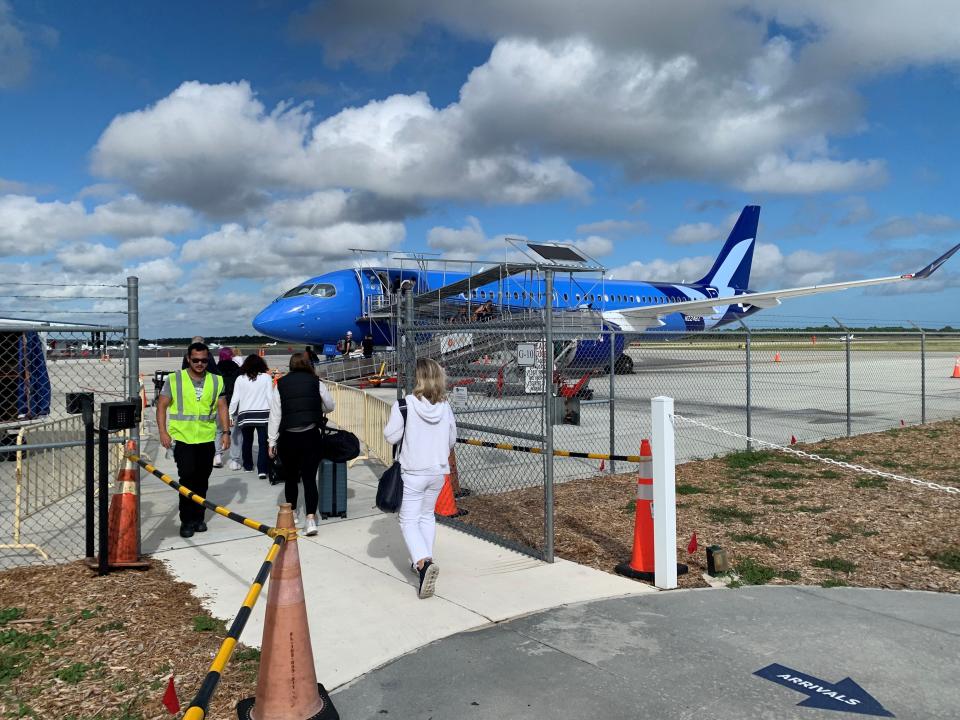 Passengers approach a Breeze Airways jet heading to Westchester County Airport in New York Nov. 10, 2023, at Vero Beach Regional Airport.