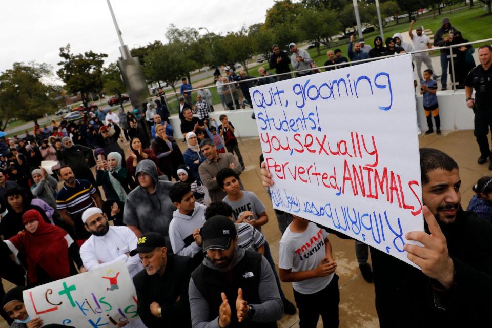 Demonstrators who support banning books gather during a protest outside of the Henry Ford Centennial Library in Dearborn, Mich., on Sept. 25, 2022. <a href="https://www.gettyimages.com/detail/news-photo/demonstrators-who-support-banning-books-gather-during-a-news-photo/1243508520?adppopup=true" rel="nofollow noopener" target="_blank" data-ylk="slk:JEFF KOWALSKY/AFP via Getty Images;elm:context_link;itc:0;sec:content-canvas" class="link ">JEFF KOWALSKY/AFP via Getty Images</a>