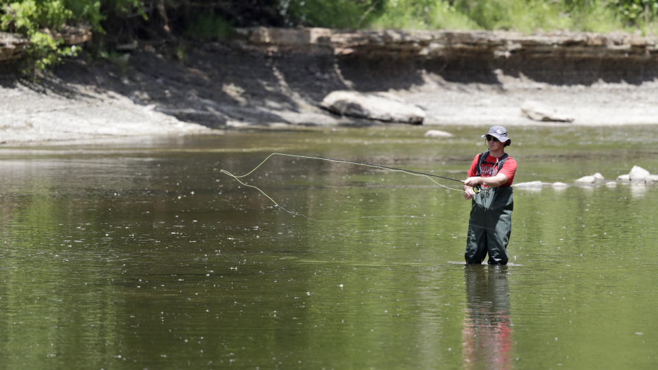 Nolan Jones fly-fishes on the Chagrin River, Tuesday, June 9, 2020, in Gates Mills, Ohio. (AP Photo/Tony Dejak)