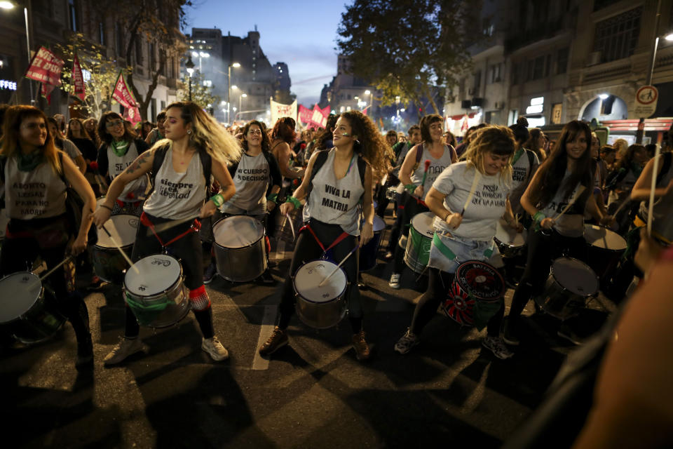 Women play drums during a protest against gender violence in Buenos Aires, Argentina, Monday, June 3, 2019. The grassroots movement "Ni una menos," or Not One Less, is marking its fourth anniversary by remembering the hundreds of women who have been murdered since its founding, and demanding laws to curb sexist violence that continues to permeate Argentine society. (AP Photo/Natacha Pisarenko)