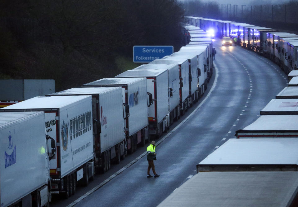 A drive sits in the cab of his lorry while parked on the M20 in Kent after the Port of Dover was closed after the French government's announcement it will not accept any passengers arriving from the UK. France appears set to end a ban on hauliers crossing the Channel which was imposed due to fears about the spread of the new coronavirus strain. (Photo by Steve Parsons/PA Images via Getty Images)