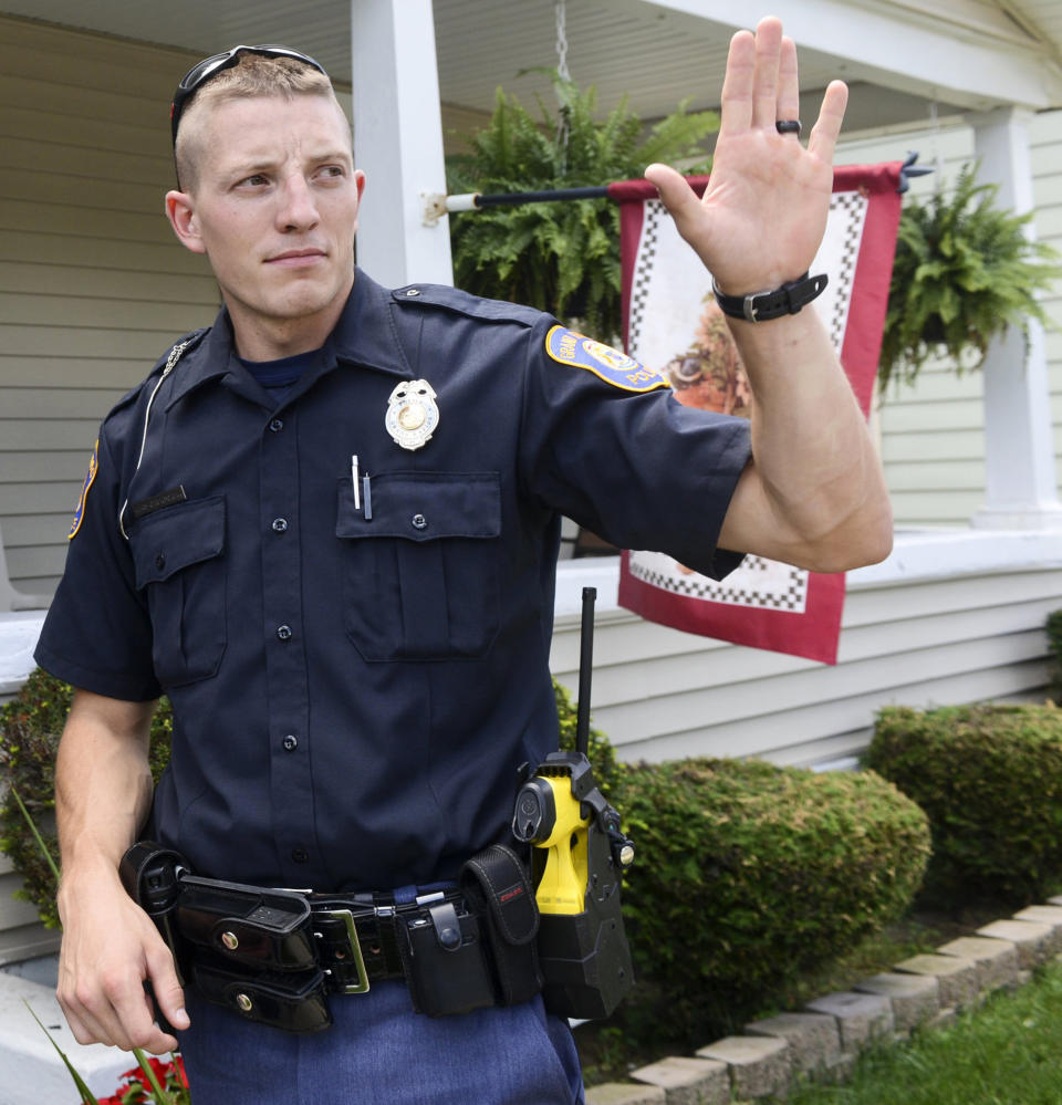 Grand Rapids Police Officer Christopher Schurr stops to talk with a resident, Wednesday, August 12, 2015, in Grand Rapids, Mich. Grand Rapids police have identified Schurr as the officer who killed Patrick Lyoya three weeks ago. Lyoya was a Black man and native of Congo who was fatally shot in the back of the head after a struggle with the officer. Police Chief Eric Winstrom had declined to name the officer but changed course Monday, April 25, 2022. He says he's doing it in the "interest of transparency" and to reduce speculation. (Emily Rose Bennett/The Grand Rapids Press via AP)