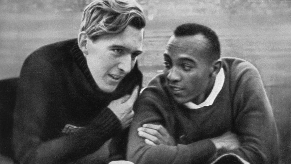 Owens (right) and Long (left) talk ahead of the long jump at the 1936 Berlin Olympics. - Juergen Lindenburger/imageBROKER/Shutterstock