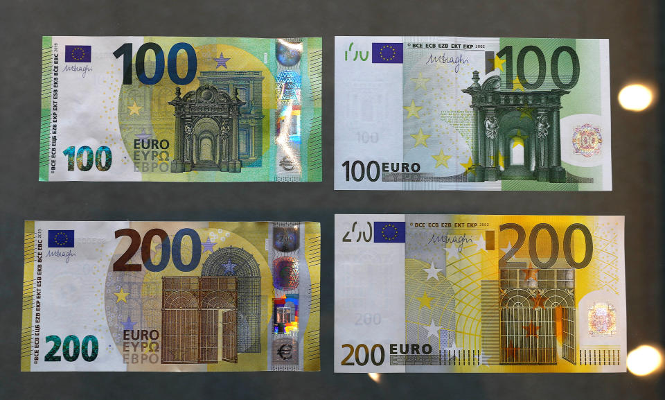 The new 100 and 200 Euro banknotes (L) are presented in comparison to the old banknotes at the headquarters of Germany's Federal reserve Bundesbank in Frankfurt, Germany, May 21, 2019.  REUTERS/Kai Pfaffenbach