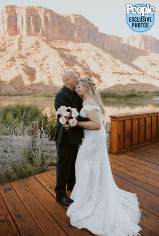 <p>Dani Sork Photo</p> Christine Brown and David Woolley embrace at their wedding