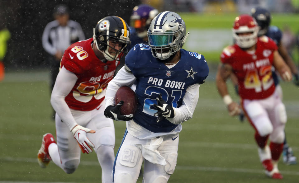 Cowboys running back Ezekiel Elliott gets away from Steelers linebacker T.J. Watt in last season's Pro Bowl in Orlando. (AP)