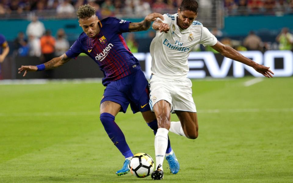 Barcelona's Neymar, left, and Real Madrid's Raphael Varane, right, go for the ball during the first half of an International Champions Cup soccer match, Saturday, July 29, 2017, in Miami - Credit: AP
