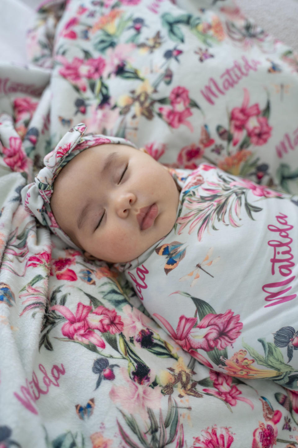 Baby sleeping in personalised swaddle