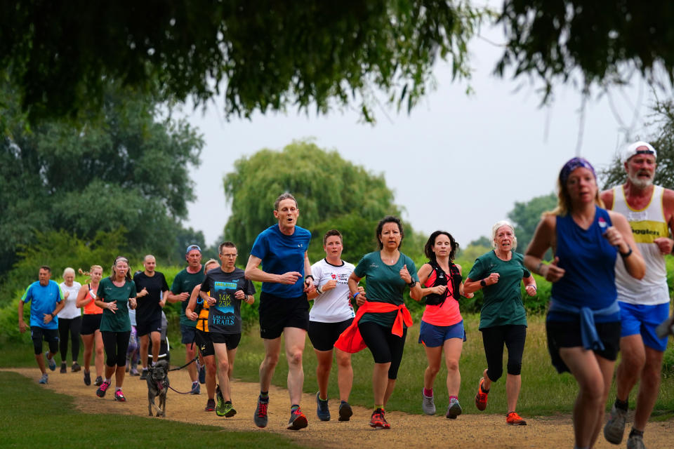 Runners taking part in the Parkrun at Bushy Park in London