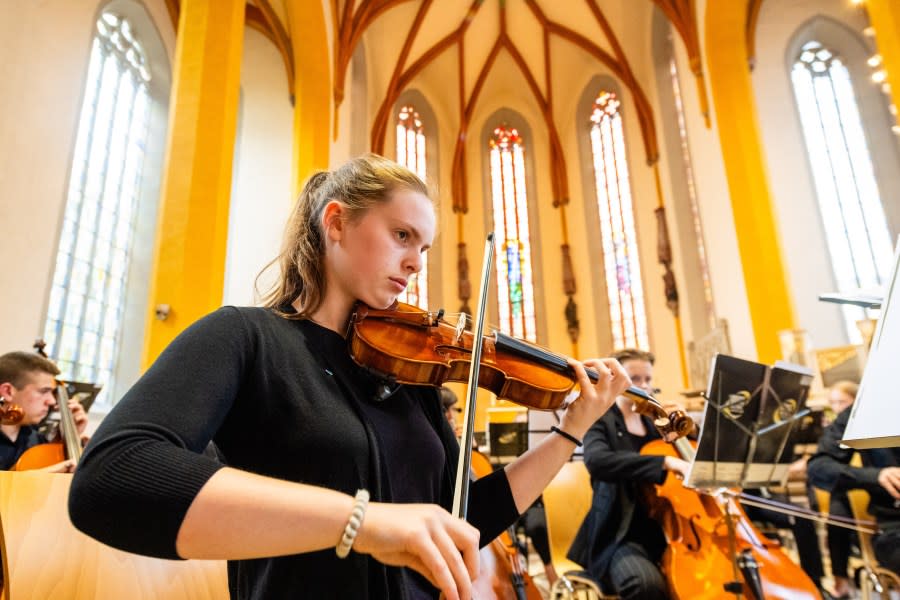 Violinist Katie Jones plays with the YSO at a church in Jena, Germany during a June 2023 European tour.