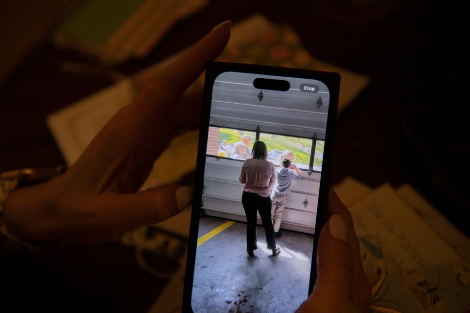 Melissa Alexander views a photograph that was taken March 27, 2023, the day of the Covenant School shooting, while she stood outside a building where students, including her son, were being held. At that time, Alexander put her hand up to the glass and had her son do the same in an effort to comfort him, Nashville, Tenn., Sunday, Nov. 26, 2023.