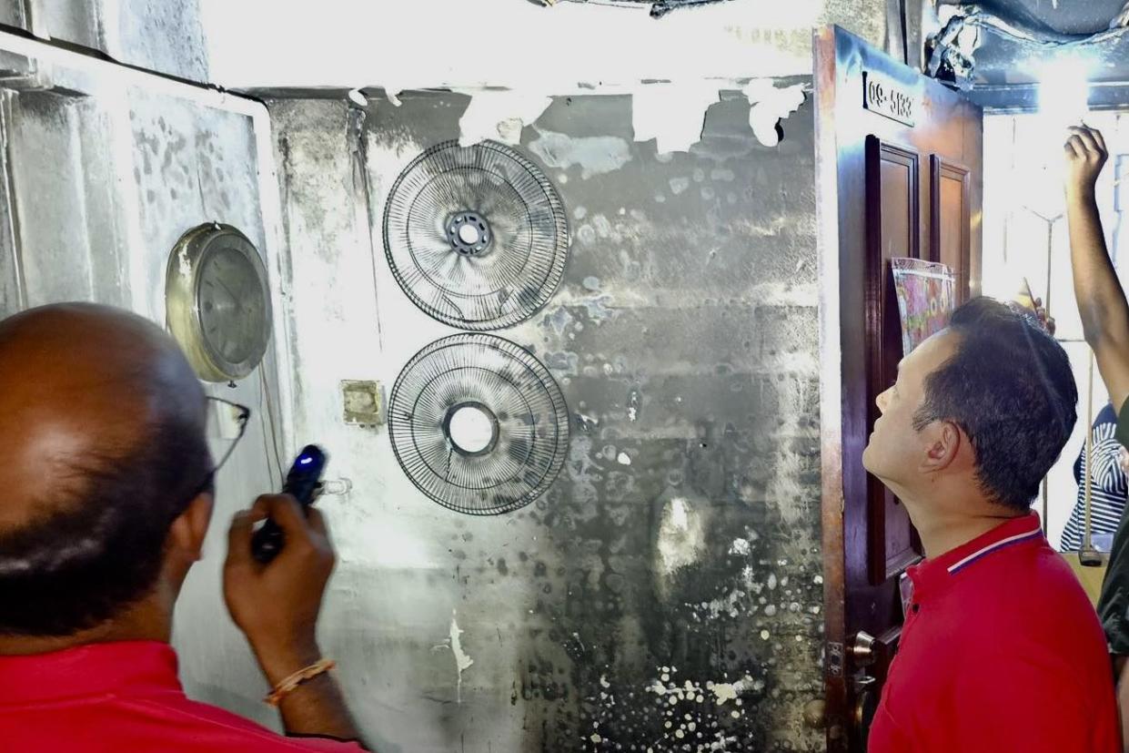 Marsiling-Yew Tee MP Zaqy Mohamed (right) inspecting one of the housing units affected by fire. (PHOTO: Facebook)