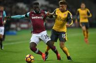 Arsenal's midfielder Alex Oxlade-Chamberlain (R) vies with West Ham United's defender Arthur Masuaku during the English Premier League football match December 3, 2016