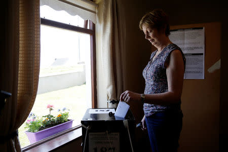 A woman casts her vote in Ireland's referendum on liberalizing abortion law, on Gola Island, Ireland, May 24, 2018. REUTERS/Max Rossi