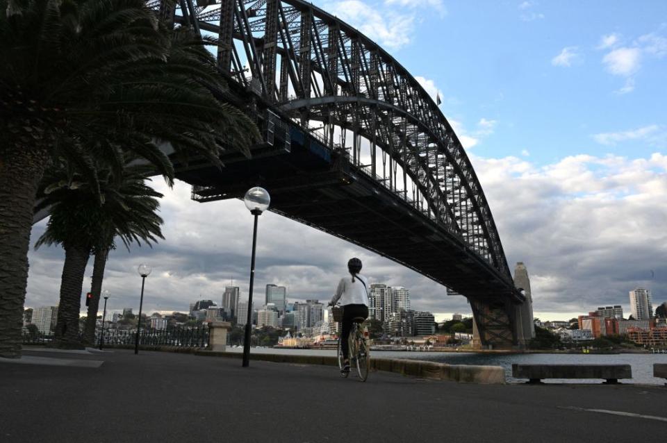 A resident rides a bike along the Sydney Harbour during the lockdown. 