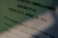 A notice related to drought conditions is posted on the door outside the Cameron County Irrigation District #2, Wednesday, Sept. 15, 2021, in San Benito, Texas. Earlier this year, before rain soaked the Rio Grande Valley in May and June, several sugarcane farmers in Irrigation District #2 were told they could only be provided one delivery of water — far less than what the thirsty crop requires. (AP Photo/Eric Gay)