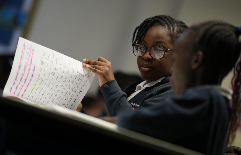 Eva, right and Fechi in year 3 as they work together on a project at the Holy Family Catholic Primary School in Greenwich, London, Wednesday, May 19, 2021. (AP Photo/Alastair Grant)