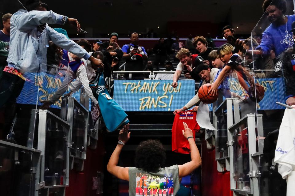 Detroit Pistons guard Cade Cunningham high-fives fans as he exits the court after the Pistons lost 123-108 to the Brooklyn Nets at Little Caesars Arena in Detroit on Wednesday, April 5, 2023.