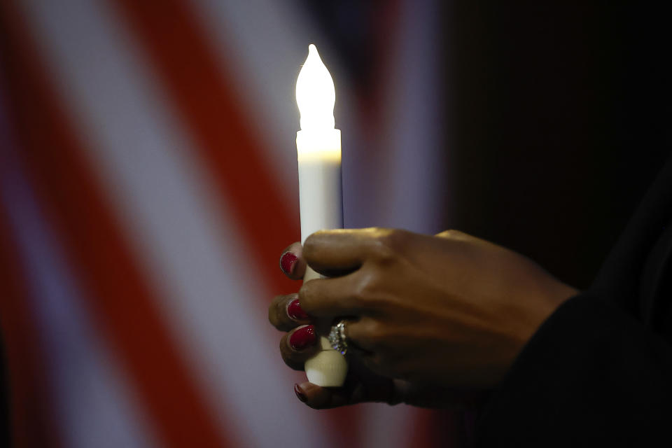 A mourner holds a candle before a memorial service for Dexter Scott King on Saturday, Feb. 10, 2024, in Atlanta. King died on Jan. 22, after battling prostate cancer. (AP Photo/Alex Slitz)